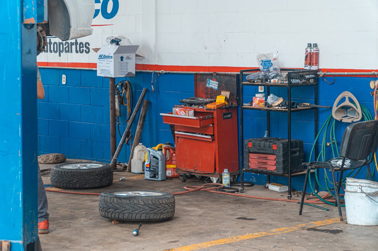 hero-img-02 A detailed view of an auto repair garage interior showcasing tools and equipment.